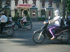 motorbike riders on a street empty by vietnam norms