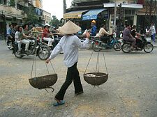 porting goods to sell around Hoan Kiem