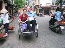 don and nga in a cyclo around Hoan Kiem